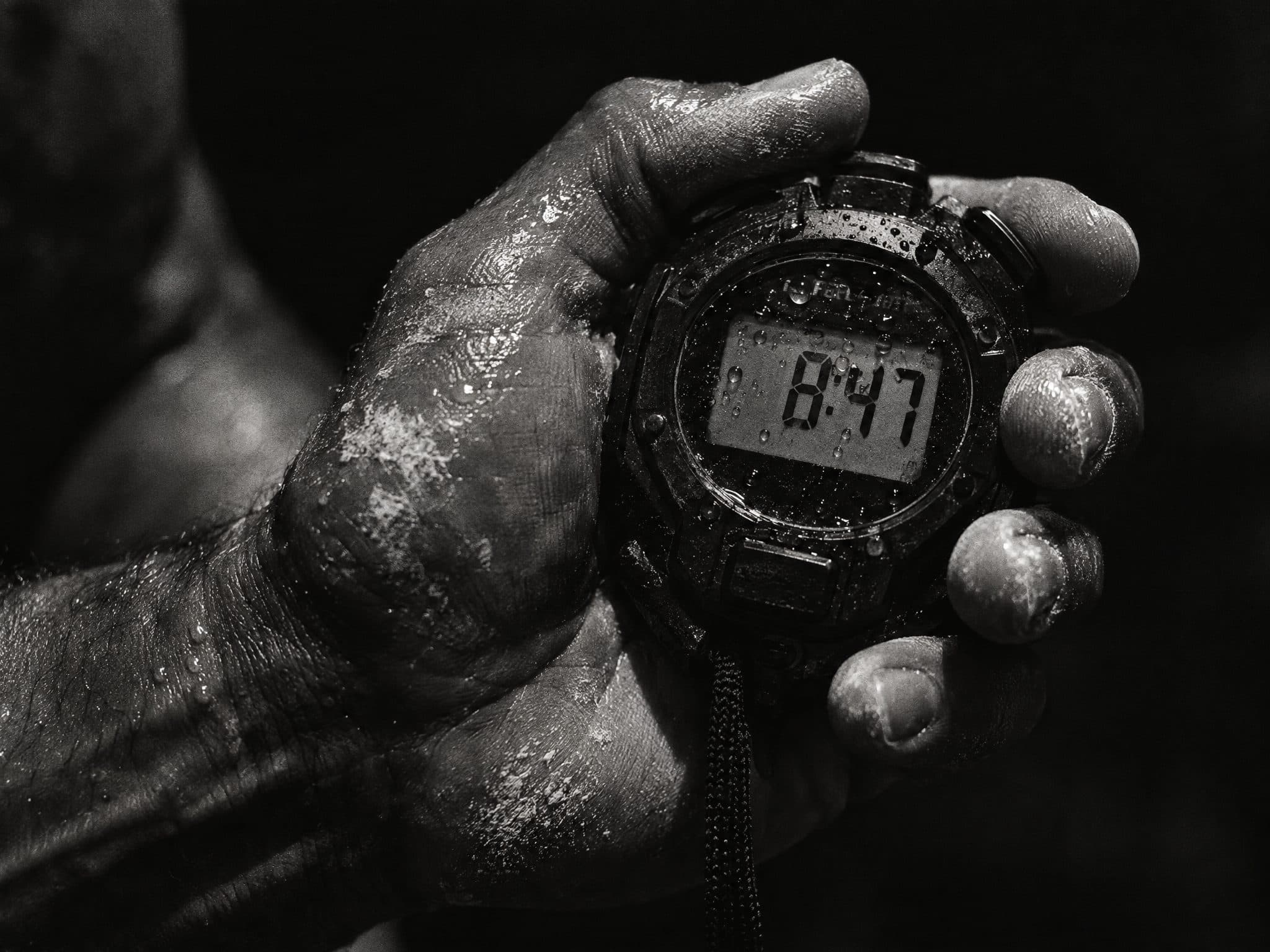 Sweaty hand holding a stopwatch reading 8:47